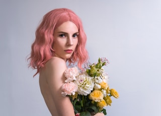 woman holding white and yellow flowers