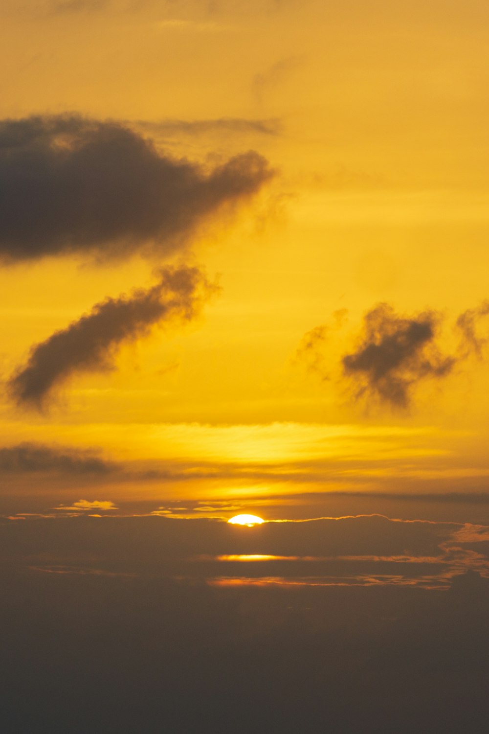 sun setting over the clouds