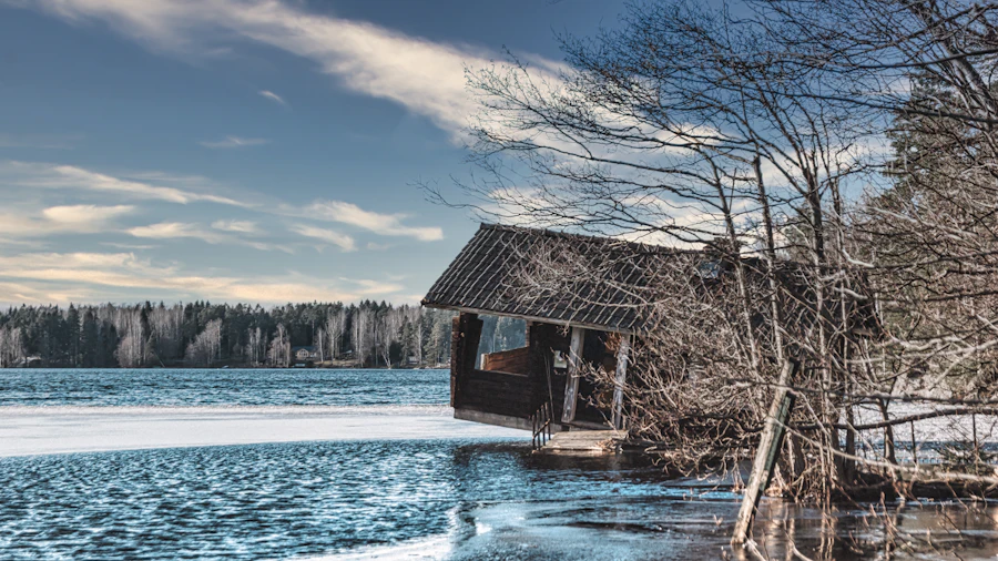 A timber sauna house on an icy lakeshore