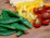 Close-up of evenly sliced cucumbers and carrots on a cutting board.