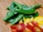 A close-up of a healthy meal prep with fresh vegetables and grains on a wooden table.