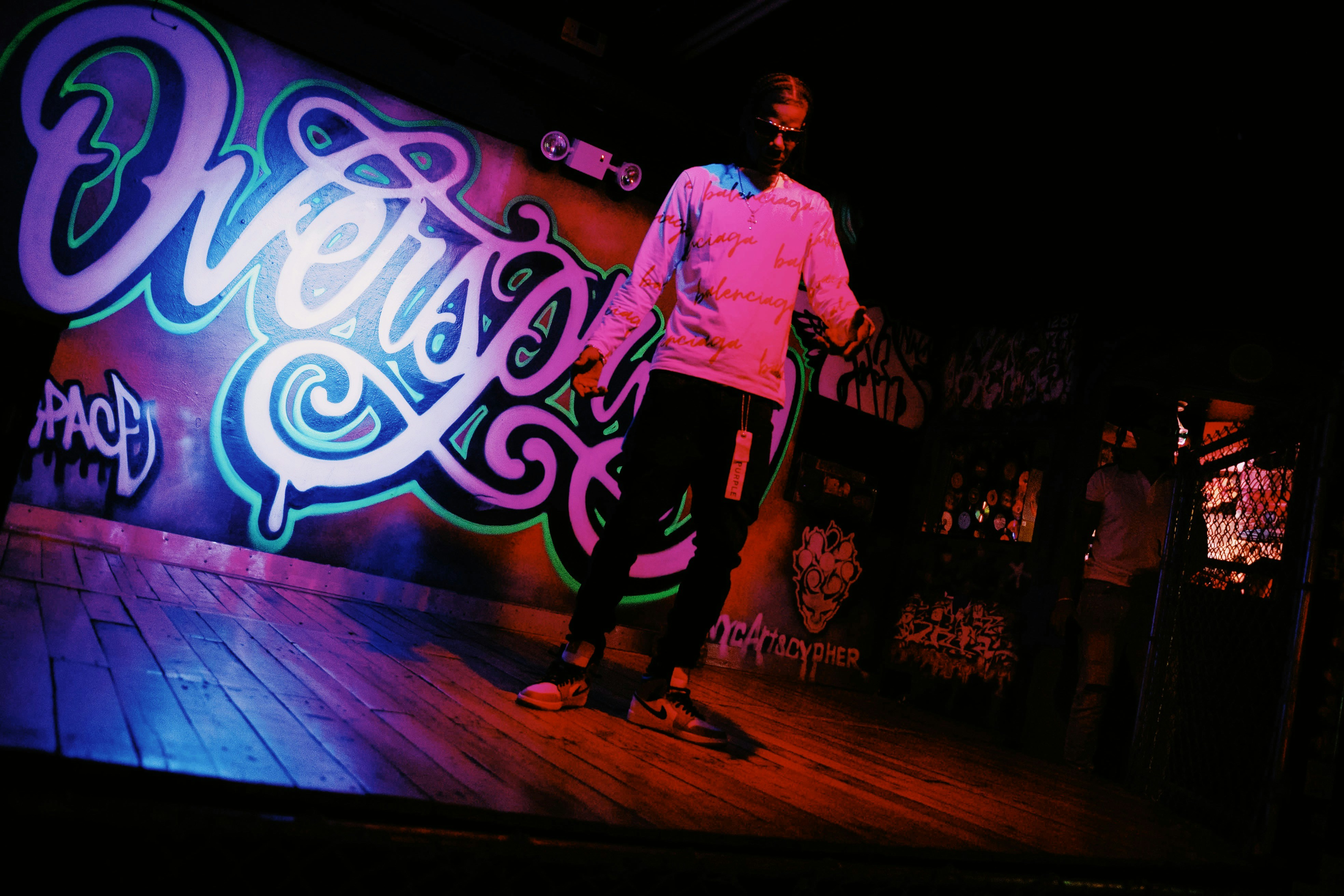 A dancer in front of a graffiti wall