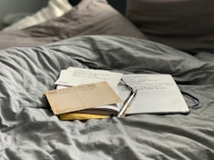 brown and white book on gray textile