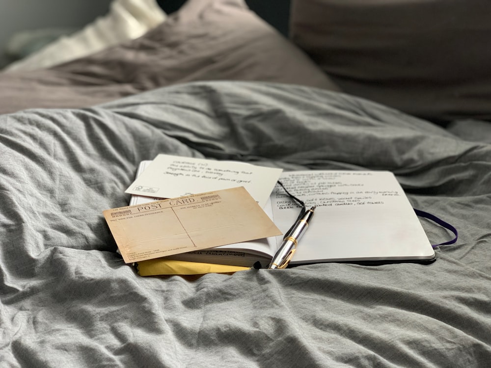 brown and white book on gray textile