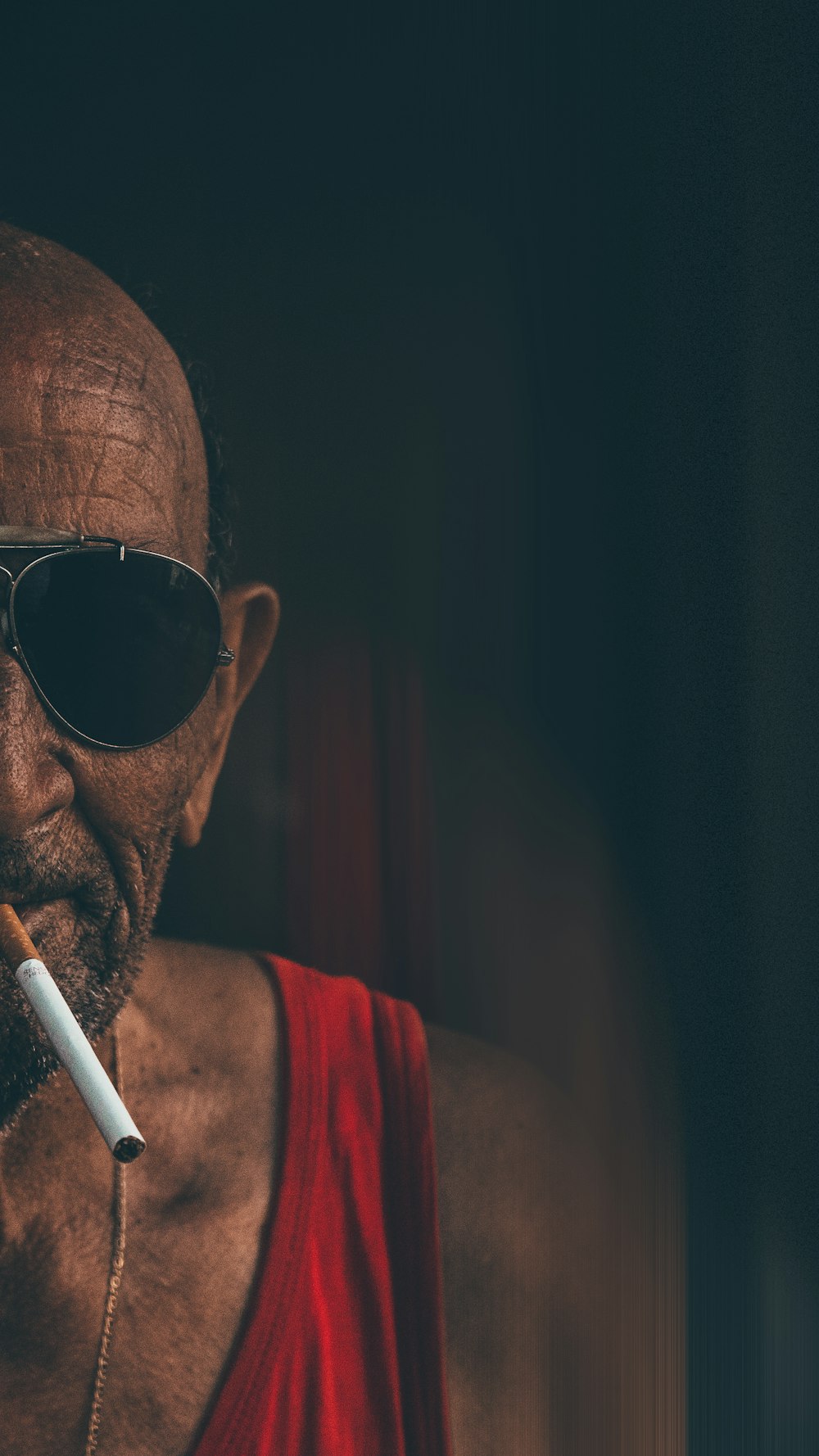 man in red tank top wearing sunglasses