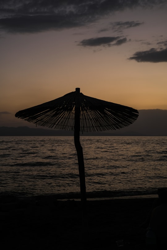 brown wooden beach umbrella on beach during sunset in Sevan Armenia