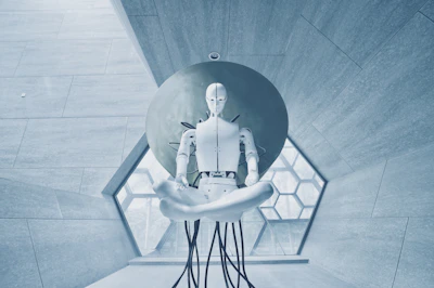A white humanoid robot in a lotus position against a large circular disc