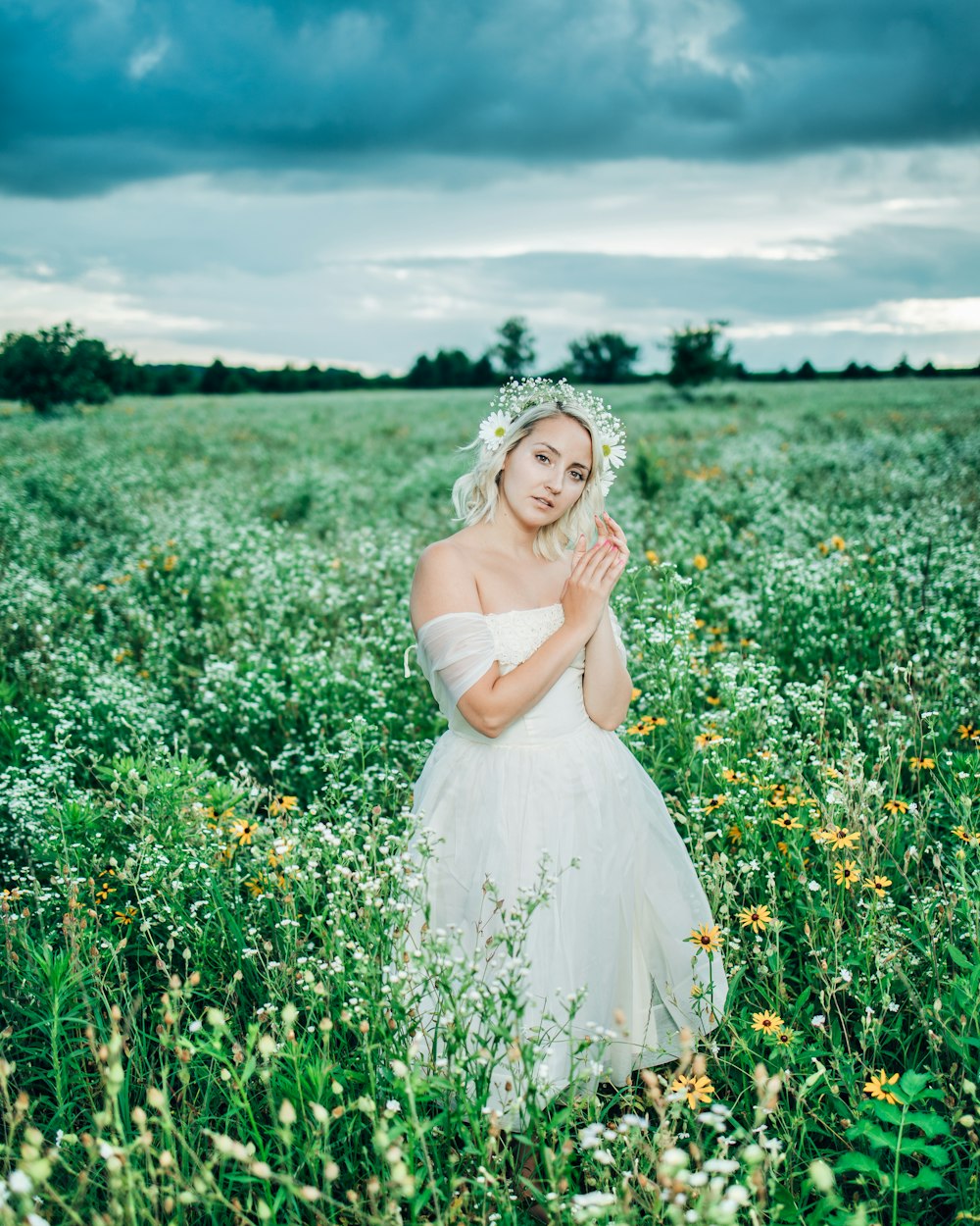 woman in white dress standing on green grass field during daytime