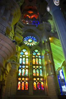Majestic stained glass window casting colorful light inside the church sanctuary