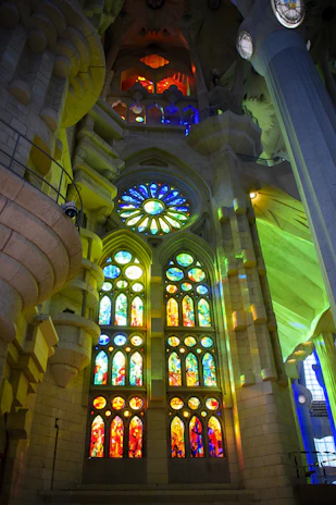 Majestic stained glass window casting colorful light inside the church sanctuary