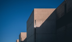 Concrete driveway with decorative patterns and clean, sharp lines under a bright sky