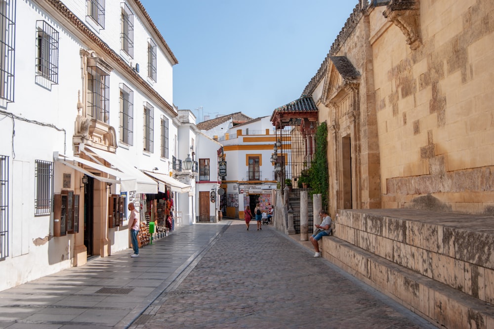 people walking on street between buildings during daytime