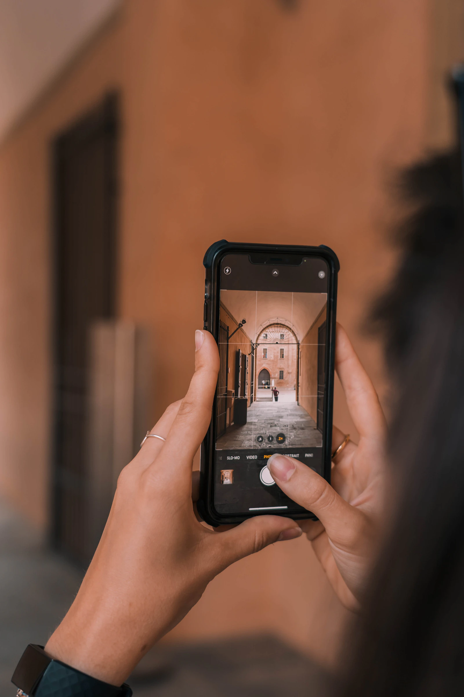 Person holding a smartphone with an interactive property viewing interface