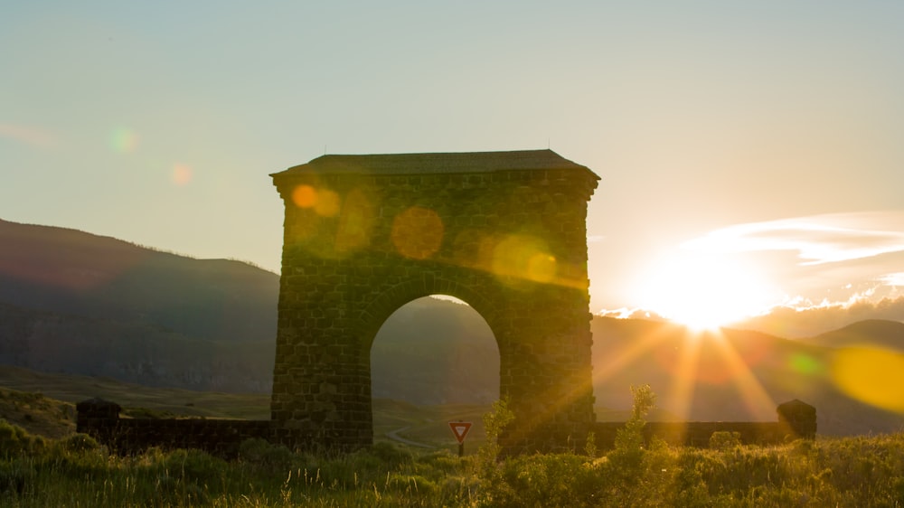 brown arch on green grass field during daytime