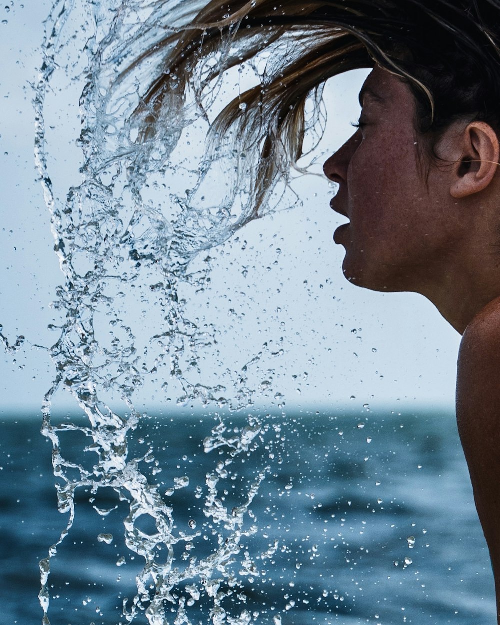 man in body of water during daytime