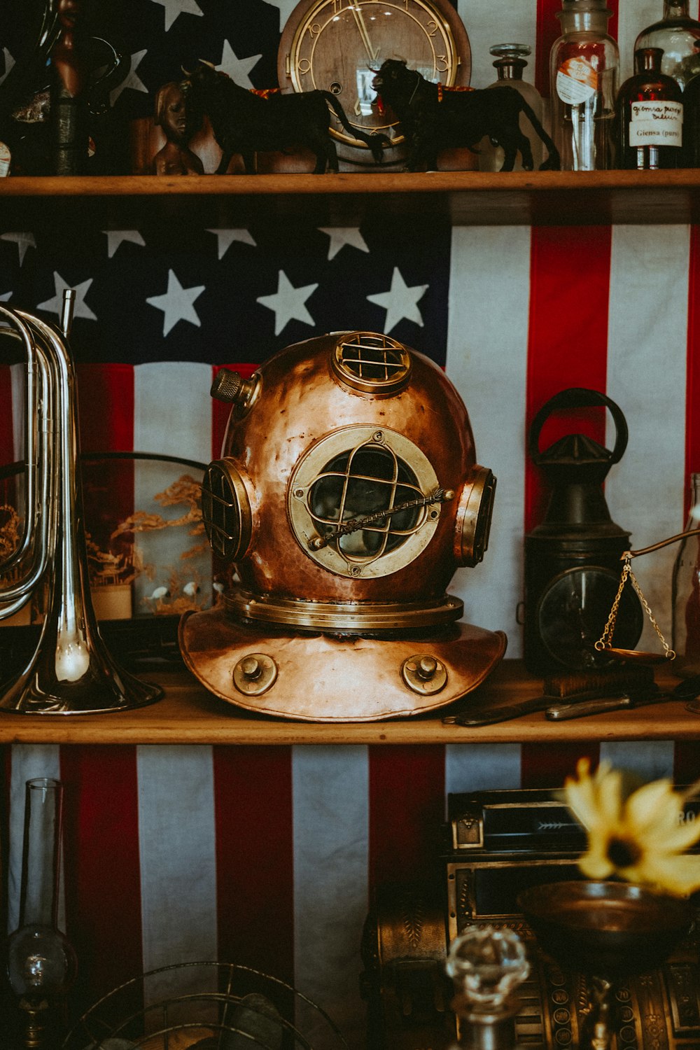 brass and silver trophy on brown wooden shelf