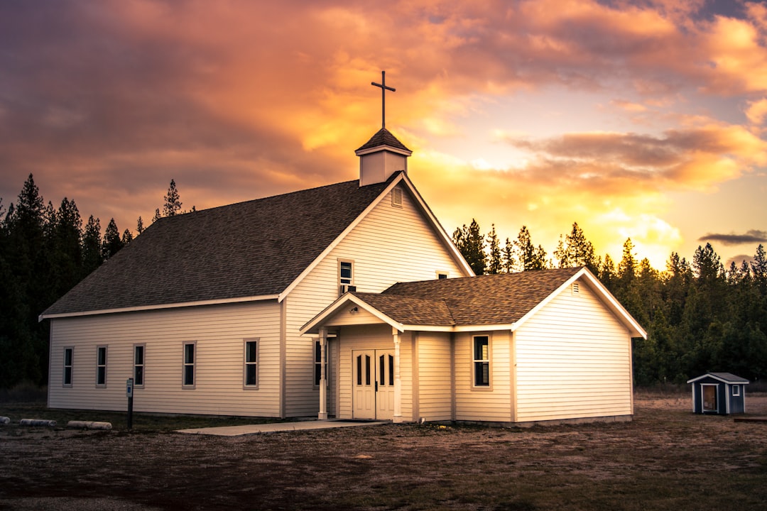 white and brown wooden church under cloudy sky during daytime