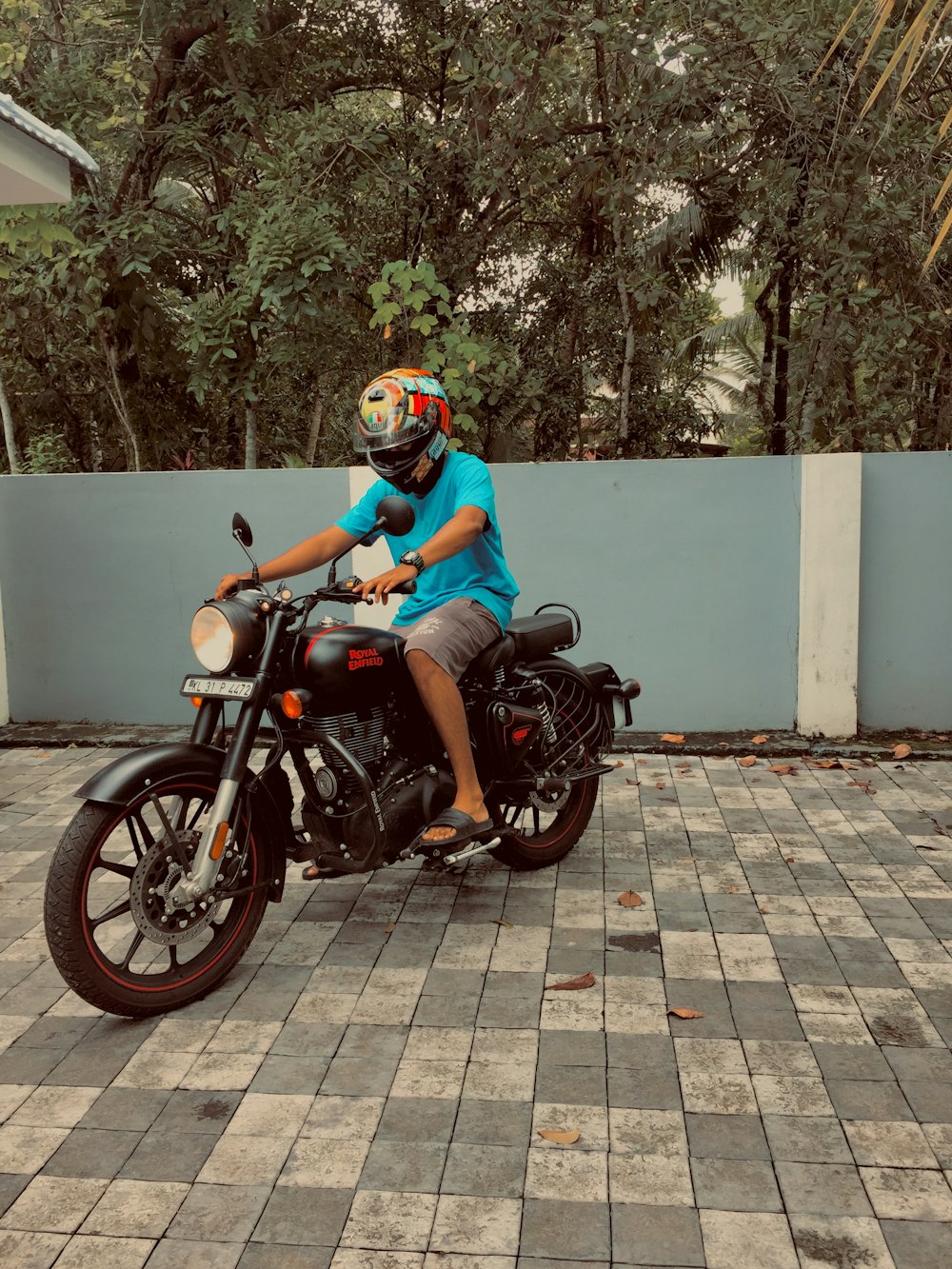 man in blue jacket riding black motorcycle