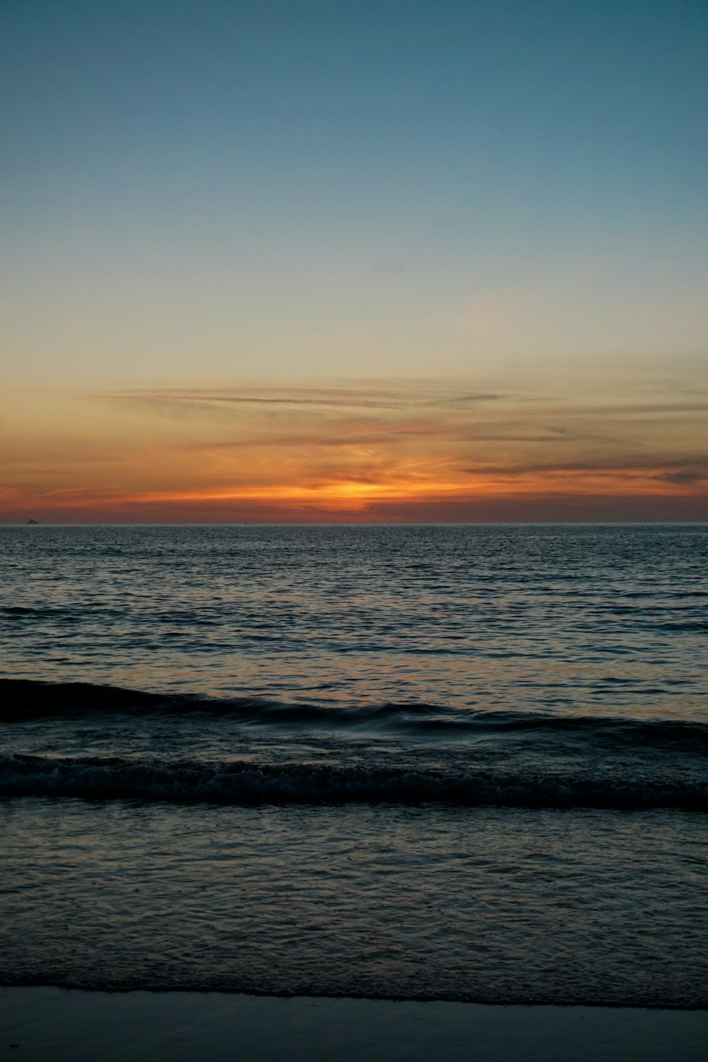 body of water during sunset