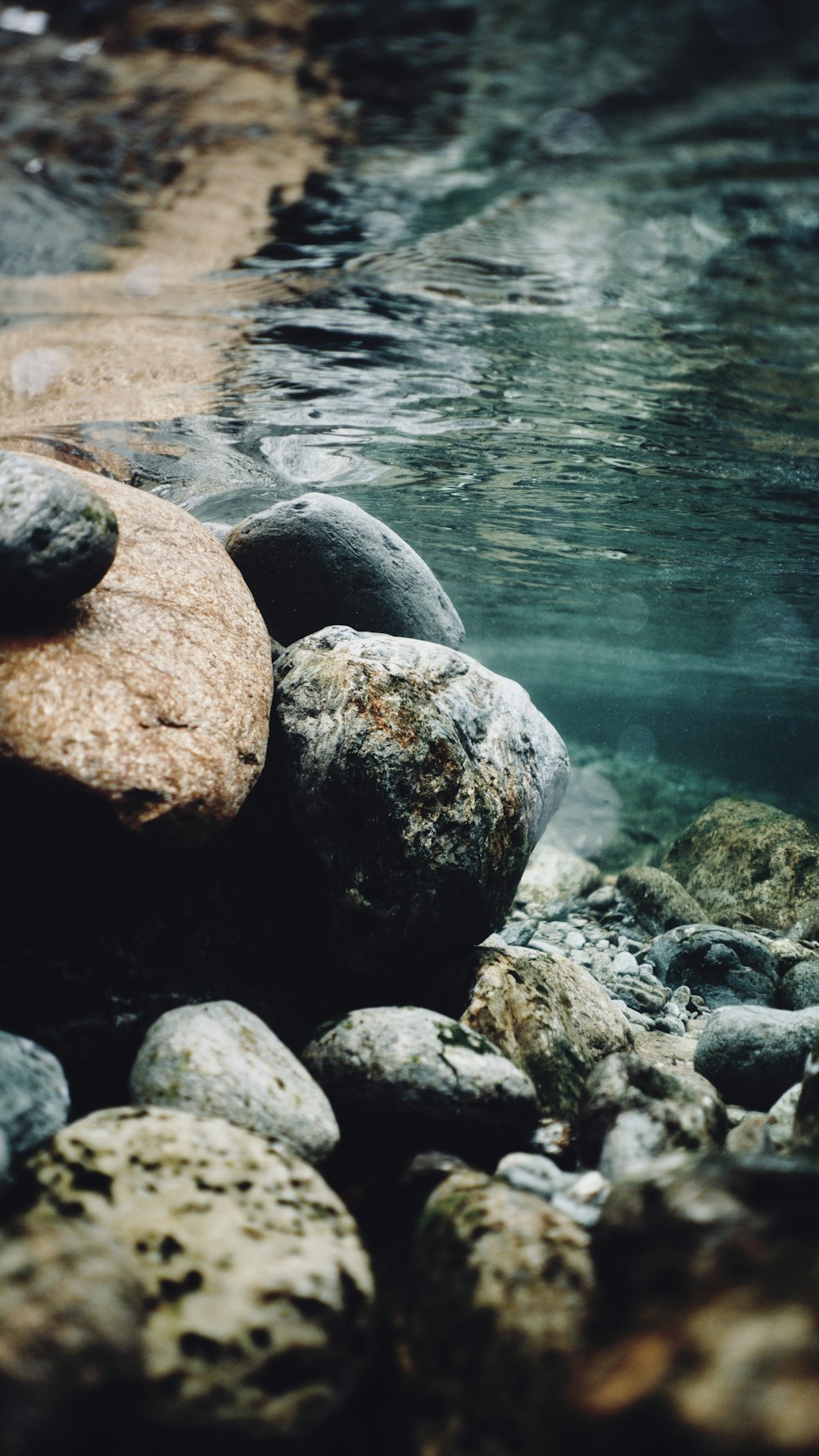 gray and black stones on body of water