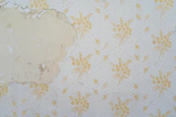 Before and after shots of wallpaper removal and smooth wall restoration in a cozy Auckland home.