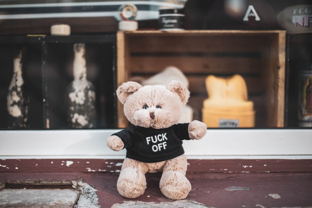 brown teddy bear on brown wooden table