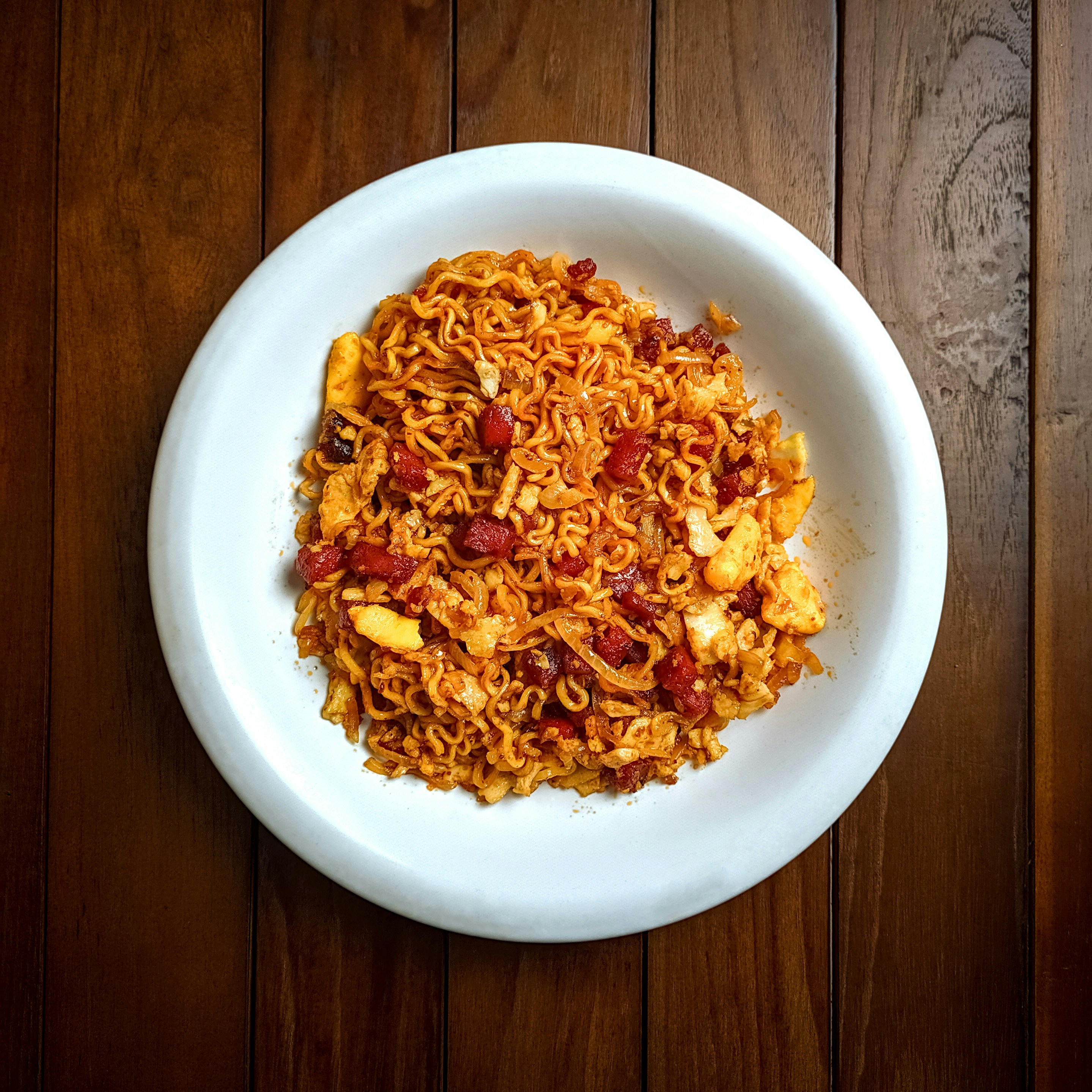 Schezwan Noodles — Spicy Schezwan sauce noodles, Indian café food photography with warm colours and appetising presentation
