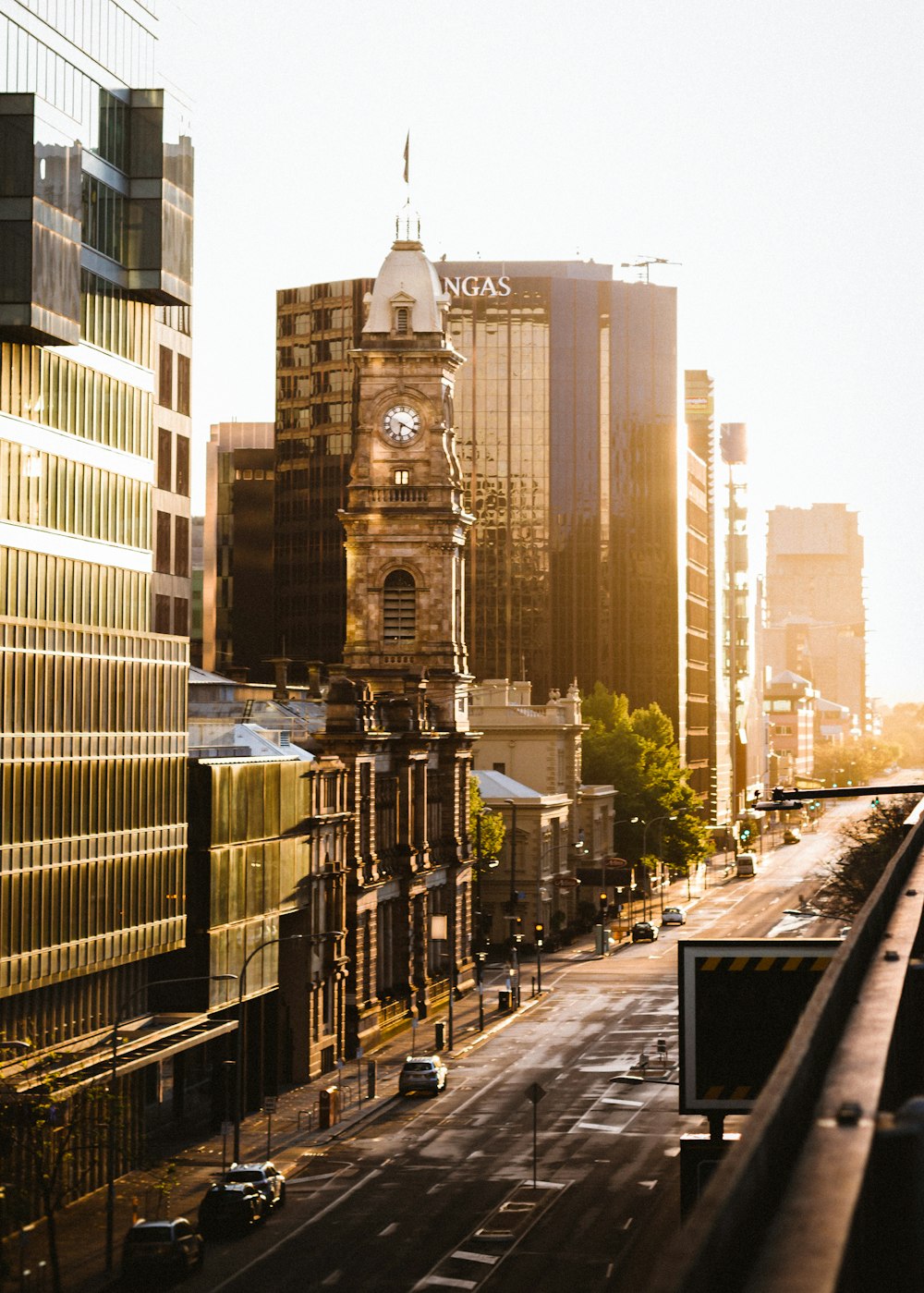 cars on road near high rise buildings during daytime