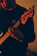 person holding brown acoustic guitar
