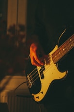 person playing electric guitar during night time