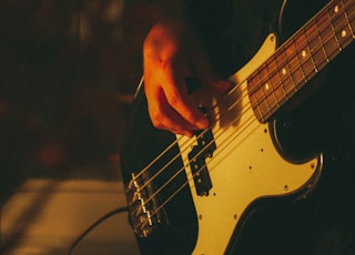 person playing electric guitar during night time