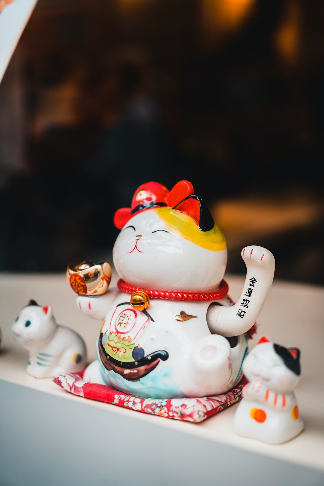 white and red ceramic cat figurines