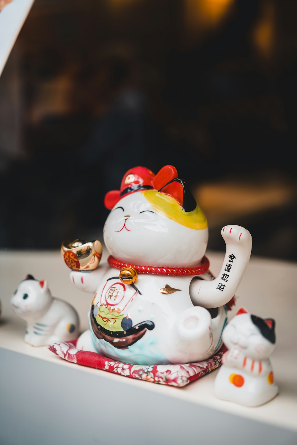 white and red ceramic cat figurines