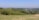 A scenic view of a traditional village landscape with green fields.