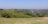 A scenic view of a traditional village landscape with green fields.