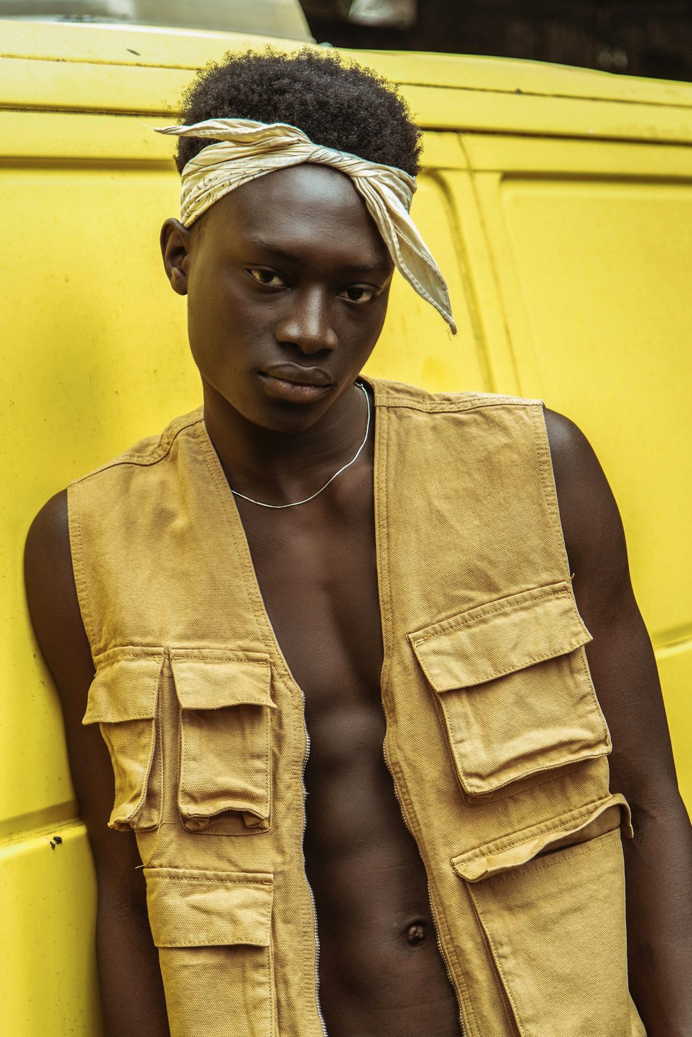 woman in yellow tank top and brown jacket