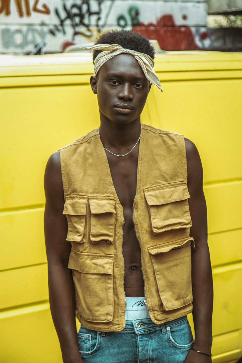 man in brown button up vest and brown tank top