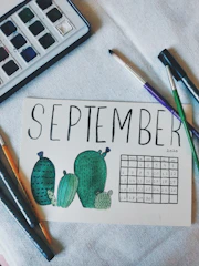 A colorful calendar page featuring custom digital artwork themed around nature and seasons.