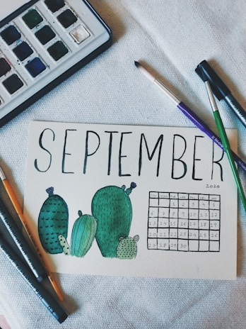 A vibrant monthly calendar page featuring lively kawaii characters around the dates.