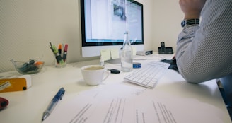 white ceramic cup on white table