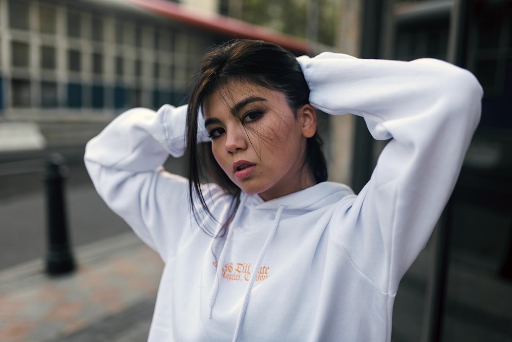 woman in white hoodie wearing black framed eyeglasses