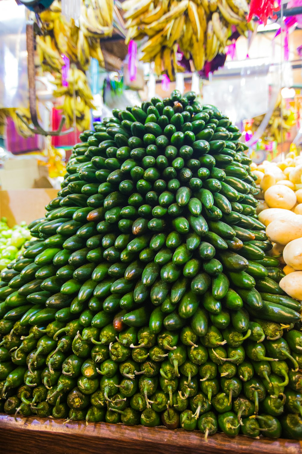 a pile of green peppers sitting on top of each other