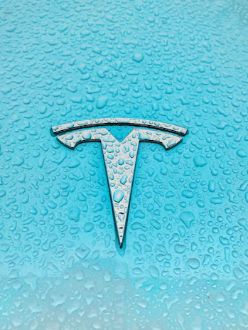 A sleek hexagonal silver tortoise shell emblem floating against a deep ocean blue backdrop.