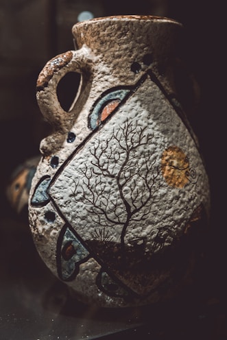 A colorful, hand-painted clay vase showcasing artisan brushwork.