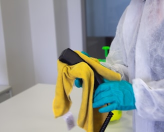 person in white robe holding black and yellow umbrella