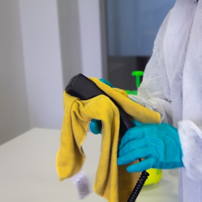 person in white robe holding black and yellow umbrella