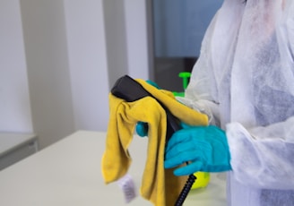 person in white robe holding black and yellow umbrella