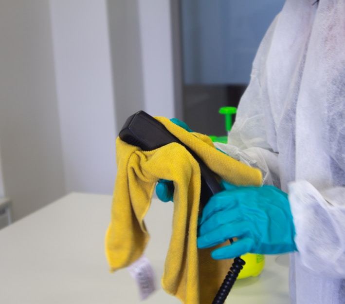 person in white robe holding black and yellow umbrella