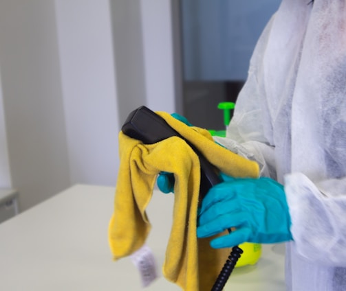 person in white robe holding black and yellow umbrella