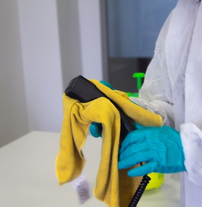 person in white robe holding black and yellow umbrella